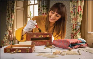  ?? Pictures: Christophe­r Ison/pa ?? English Heritage curator Olivia Fryman inspecting a keepsake box that once belonged to the daughters of Charles Darwin and which has been returned to the family home in Kent, England