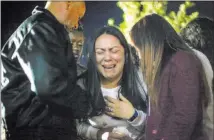  ??  ?? Elena Pineda, the mother of Helena Lagos, collapses during a vigil for her daughter in North Las Vegas.