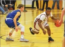  ?? THOMAS NASH - DIGITAL FIRST MEDIA ?? Pottsgrove’s Manny Clark works to get around the defense of Great Valley’s Damien Carter during the first half of Tuesday’s game.