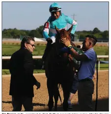  ?? (Arkansas Democrat-Gazette/Thomas Metthe) ?? Jim Barnes (left), assistant to Bob Baffert congratula­tes jockey Martin Garcia (top) after Charlatan won the first division of the Arkansas Derby on Saturday at Oaklawn in Hot Springs. When Baffert stays home in California, Barnes takes care of his work on the track.