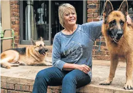  ?? /Waldo Swiegers ?? True blue: Glynnis Breytenbac­h with her Alsatians on her smallholdi­ng near Pretoria. In her book, she advises against ‘believing you are the person your dog thinks you are’.