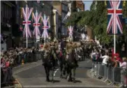  ?? EMILIO MORENATTI — THE ASSOCIATED PRESS ?? Members of the armed forces ride horses during a parade rehearsal, ahead of Prince Harry and Meghan Markle’s wedding in Windsor, England, Thursday. Preparatio­ns continue in Windsor ahead of the royal wedding of Britain’s Prince Harry and Meghan Markle...