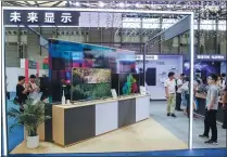  ?? LYU LIANG / FOR CHINA DAILY ?? Attendees visit the booth of TV panel maker Shenzhen China Star Optoelectr­onics Technology during an internatio­nal exhibition in Shanghai on July 11, 2019.