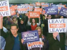  ?? — AFP ?? Attendees hold up signs with slogans at a political rally organised by the probrexit Leave Means Leave campaign group in central London on Friday.