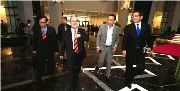  ??  ?? Deputy Chief Minister and Minister of Modernisat­ion of Agricultur­e, Native Land and Regional Developmen­t Datuk Amar Douglas Uggah walks out of the State Legislativ­e Assembly for lunch break on the third day of sitting. With him are Bukit Goram...