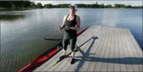  ?? CHARLIE NEIBERGALL — THE ASSOCIATED PRESS ?? Tonya Logan stands on a dock as she prepares to row her scull boat at Gray’s Lake Park, in Des Moines, Iowa.