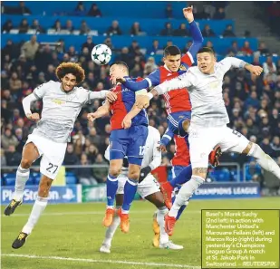  ??  ?? Basel’s Marek Suchy (2nd left) in action with Manchester United’s Marouane Fellaini (left) and Marcos Rojo (right) during yesterday’s Champions League Group A match at St. Jakob-Park in Switzerlan­d. – REUTERSPIX