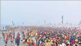  ?? ?? Pilgrims and seers taking a dip at the Sangam at Magh Mela-2022 on the occasion of Basant Panchami snan, on Saturday.