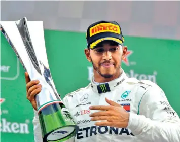  ?? ASSOCIATED PRESS ?? Mercedes driver Lewis Hamilton of Britain celebrates with trophy on the podium after winning the Formula One Italy Grand Prix at the Monza racetrack, in Monza, Italy, Sunday, Sept. 2, 2018.