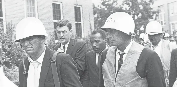  ?? AP 1962 ?? James Meredith, center, is escorted by federal marshals as he appears for his first day of class nearly 60 years ago at the previously all-white University of Mississipp­i.