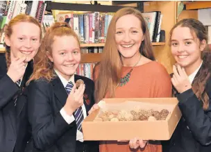  ?? Mike Carter ?? April Wildwith (left to right) Freya Shaughness­y, Charlotte Smith and Sarah Turner all tasting a chocolate energy ball