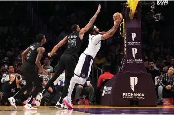  ?? — AFP photo ?? Anthony Davis (right) of the Los Angeles Lakers scores a basket against the Brooklyn Nets during the first half of the game at Crypto.com Arena in Los Angeles, California.