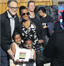  ?? HABITAT FOR HUMANITIES. ?? Finance Minister Joe Ceci celebrates with families taking possession of homes at a Habitat for Humanities site.