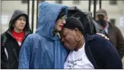  ?? ?? Estephanie Ward gives Jannie Mitchell a hug during a demonstrat­ion in Washington.