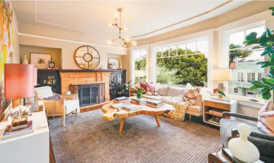  ?? Photos by Open Homes Photograph­y ?? Above: South-facing, dual-glazed bay windows in the living room overlook 17th Street. Below: The home at 4422 17th St. in Corona Heights is a three-bedroom, two-bathroom built in the 1920s available for $1.85 million.