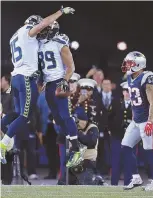  ?? STAFF PHOTO BY MATT WEST ?? UPS AND DOWNS: Patrick Chung walks away as the Seahawks’ Doug Baldiwn (89) celebrates a touchdown with Jermaine Kearse last night.