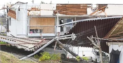  ??  ?? Damage to a residentia­l apartment caused by Typhoon Jongdari is seen in Nara. — AFP photo