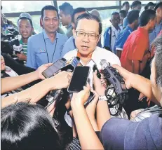  ??  ?? Lim (centre) talks to reporters at the function. — Bernama photo