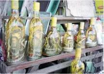  ??  ?? FAR AND WIDE: Wildlife medicine, such as these bottle of snake oil in Vietnam, are sold all over the world.