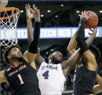  ?? ELISE AMENDOLA — THE ASSOCIATED PRESS ?? Villanova’s Eric Paschall, center, jousts for a rebound with Texas Tech’s Brandone Francis, left, and Justin Gray during the first half of their East Regional final Sunday. Paschall scored 12 points and corralled a career-high 14 boards to help...