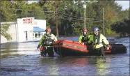  ?? Joe Raedle / Getty Images ?? Members of New York Urban Search and Rescue Task Force One work in an area flooded with waters from the Little River as it crests from the rains caused by Hurricane Florence as it passed through the area Tuesday.