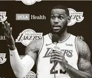  ?? Frederic J. Brown / Getty Images ?? LeBron James reportedly thinks restarting the season wouldn’t deter him from pushing for change.