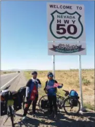  ?? SUBMITTED PHOTO ?? Amit and Ajit Baral hold the Nepalese and American flags on “America’s Loneliest Highway.”