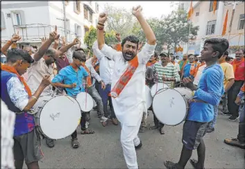  ?? Ajit Solanki The Associated Press ?? Supporters of the World Hindu Council celebrate outside the organizati­on’s office in Ahmadabad, India, on Saturday following a ruling by India’s Supreme Court in favor of constructi­ng a Hindu temple on disputed religious ground.