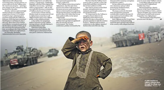  ??  ?? A child watches as military vehicles drive through his village near Kandahar. Photos / AP