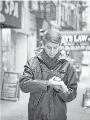  ?? Erin Patrice O’Brien / New York Times ?? Daniel Poston, a medical student in New York, uses his Apple Watch for a heart study financed by Apple.