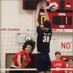  ?? MIKE BUSH/NEWS-SENTINEL ?? Lodi's Gavin Peters spikes the volleyball past Pleasant Grove's Noah Wagner (32) in Friday's nonleague match against Pleasant Grove inside the old Inferno.