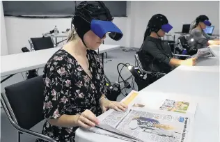  ?? PHOTO: NZ HERALD ?? Focused . . . During a study by neuroscien­tists, newspaper readers were shown to be highly engaged.