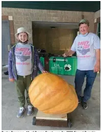  ?? (Special to The Commercial) ?? Buster Passmore, 11, of Greene County won the 2020 Biggest Pumpkin contest with a 334-pound pumpkin. At right is his dad, Mark Passmore.