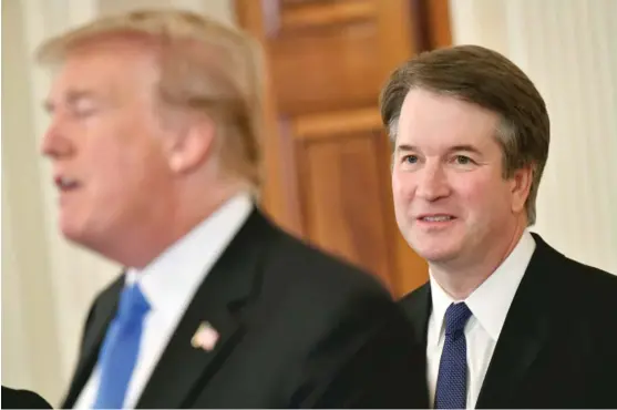  ?? MANDELNGAN/ AFP/ GETTY IMAGES ?? ABOVE: Brett Kavanaugh listens to President Donald Trump announcing his nomination for the Supreme Court on Monday at the White House.