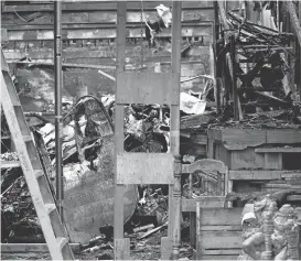  ?? JANE TYSKA/STAFFARCHI­VES ?? A wooden staircase built on top of pallets is seen, right, as investigat­ors carry on their work at the Ghost Ship warehouse in Oakland. Thirty-six people died in the Dec. 2 fire on 31st Avenue and Internatio­nal Boulevard.