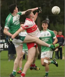  ??  ?? Niall Hughes battling in the air with Seán Lyster of St. Mary’s.
