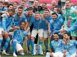  ?? — AP ?? Manchester City players celebrate with the trophy after winning the League Cup final against Tottenham Hotspur 1-0 at the Wembley Stadium in London on Sunday.