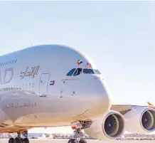  ??  ?? Etihad Airways’ A380 pilot waves flags from the United Arab Emirates and the United States to celebrate A380 inaugural service between New York’s John F. Kennedy Internatio­nal Airport and Abu Dhabi.