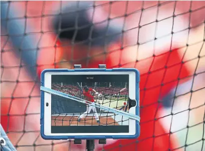  ?? OMAR RAWLINGS GETTY IMAGES ?? The Red Sox use an iPad to record J.D. Martinez practising. Technology is a big part of the game, but some worry about cheating.