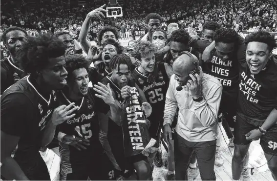  ?? Patrick Smith / Getty Images ?? Coach Shaheen Holloway and Saint Peter’s are the first No. 15 seed to advance to the NCAA Tournament’s Elite Eight. The Peacocks face No. 8 North Carolina.