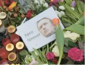  ?? SEAN GALLUP/GETTY ?? A photo of Alexei Navalny lies at a memorial Saturday near the Russian Embassy in Berlin.