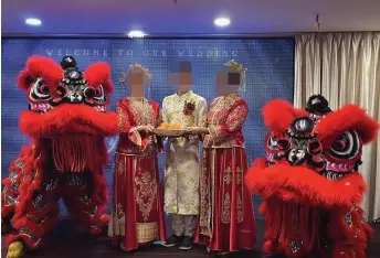  ?? ?? The groom and his two supposed brides are pictured in traditiona­l Chinese wedding costumes during the reception.