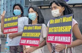  ?? THE NEW YORK TIMES ?? Protesters decry the recent coup Tuesday in Yangon, Myanmar. The trial of civilian leader Aung San Suu Kyi and deposed President Win Myint began Tuesday.