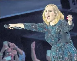  ?? Francesco Prandoni Getty Images ?? ADELE performs in one of the many identical dresses in Verona, Italy, in May.