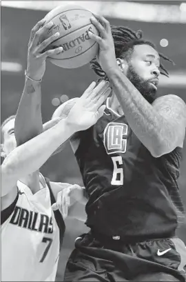  ?? Photograph­s by Wally Skalij Los Angeles Times ?? CLIPPERS CENTER DeAndre Jordan, in front of Dallas Mavericks forward Dwight Powell, pulls down one of his game-high 13 rebounds.