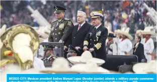  ?? —AFP ?? MEXICO CITY: Mexican president Andres Manuel Lopez Obrador (center) attends a military parade commemorat­ing the 112th anniversar­y of the Mexican Revolution at the Zocalo square in Mexico City.