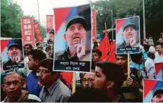  ?? AFP ?? Leftists carry placards bearing the image of Fidel Castro in Kolkata yesterday. Leftist leaders said the Cuban icon had been a shining beacon of the Communist movement.