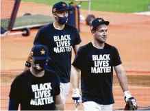  ?? Karen Warren / Staff photograph­er ?? Aledmys Diaz, from left, Carlos Correa and Alex Bregman wear Black Lives Matters T-shirts before the start of the game Friday.