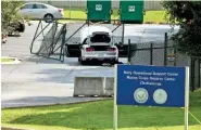  ?? THE ASSOCIATED PRESS ?? A car tangled in fencing sits parked just inside the gate at the U.S. Naval and Marine Reserve Center on Friday in Chattanoog­a. A gunman opened fire Thursday killing four U.S. Marines.