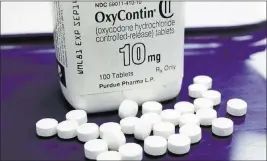  ??  ?? The Associated Press While prescripti­on medication­s such as Oxycontin probably won’t ever be shelved for good — they’re just too potent — fears of addiction are leading drugmakers to experiment with alternativ­es using natural substances with...